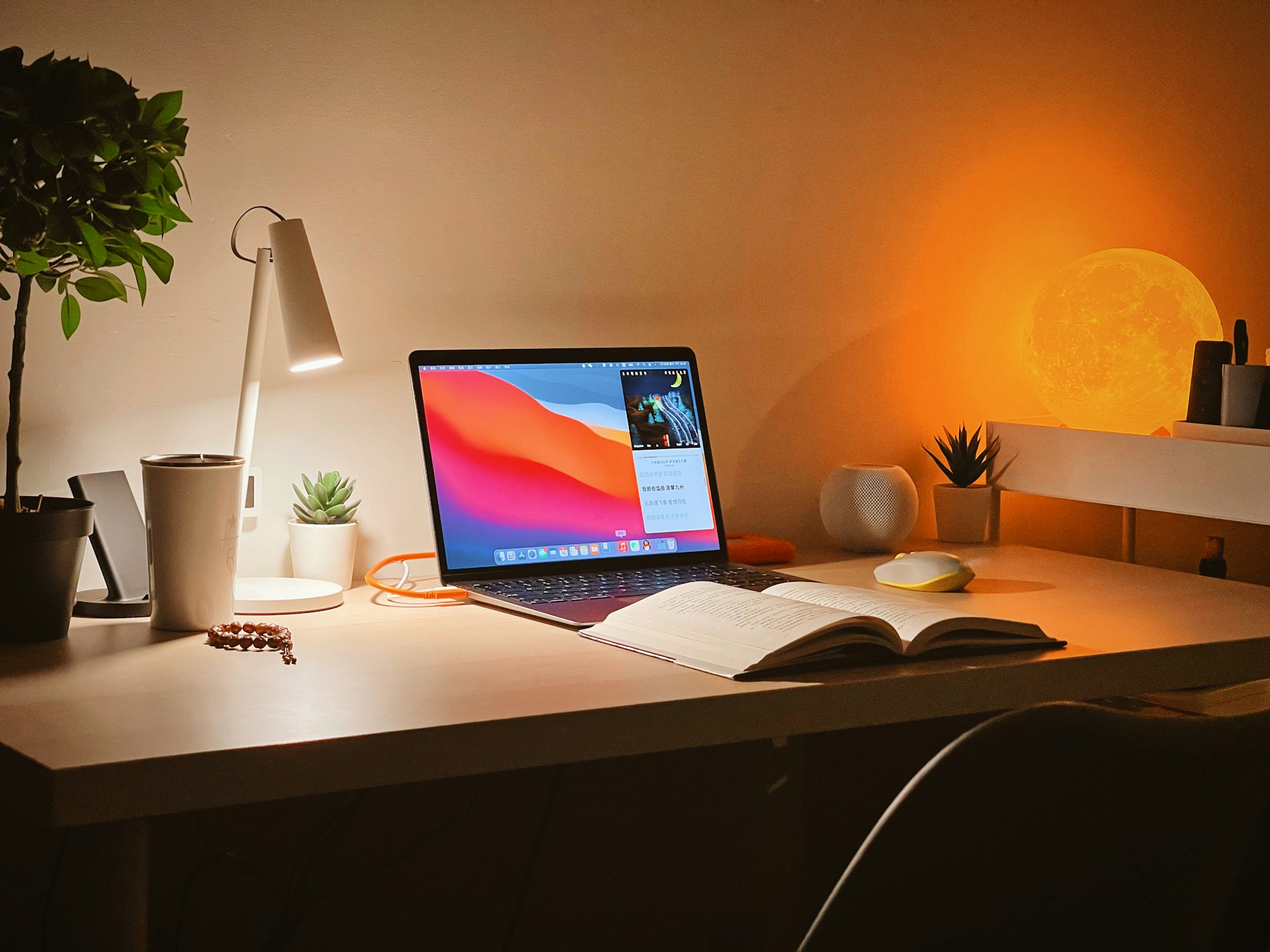 A student's warmly lit evening desk with an open textbook, laptop, notebook and coffee mug, the focused study setup for practicing active recall, the science-backed technique that doubles what you remember.